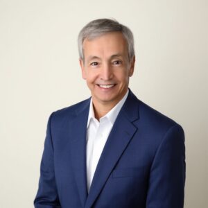 Smiling professional in navy blazer and white shirt