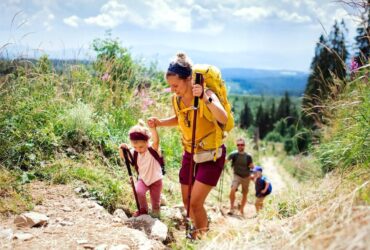 Family hiking uphill in a scenic landscape.